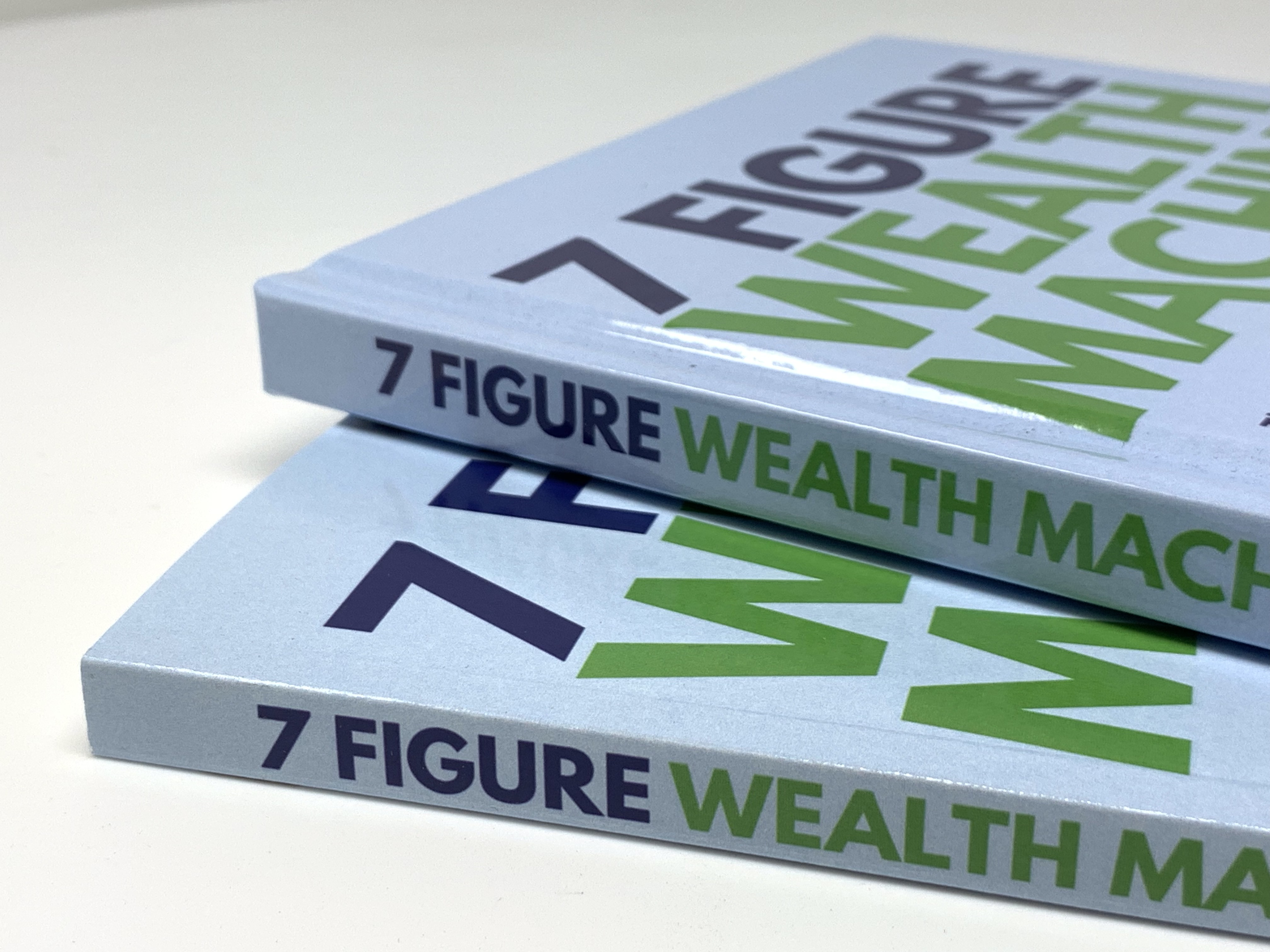"7 Figure Wealth Machine" books in hardcover and paperback