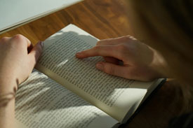 Back of woman's head reading a book